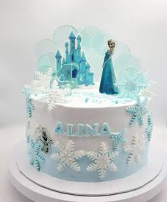 a frozen princess cake with snowflakes and frosting on it's sides