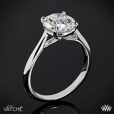 a close up view of a diamond ring on a black background with the words watche written below it