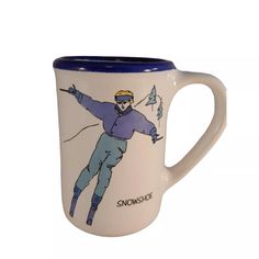 a ceramic mug with a skier on it