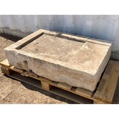 a large stone slab sitting on top of pallets