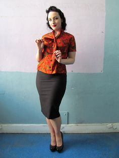 "Super cute novelty print silky blouse from the 1940s. Button up style with an ascot tie collar. Elastic inserts at the waist sides add a bit of flex room in the waistline. Measurements: // Shoulders: up to \" taken flat Bust: 40\"max Waist: 30\" to 32\" max Length: 22\"" Retro Collared Blouse For Work, Retro Fitted Blouse For Office, Vintage Tie Neck Office Top, Retro Workwear Blouse With Peter Pan Collar, Vintage Office Tie Neck Top, Vintage Tie Neck Top For Office, Fitted Retro Workwear Blouse, Retro Peter Pan Collar Blouse For Work, Retro Button-up Workwear Blouse