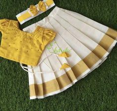 Kids Onam Dress Fabric and Work: Top: Rawsilk top with scattered beads enhances the appearance of the choli. It's made of rawsilk fabric. The dress is lined with soft cotton fabric. The top has hook opening at back side. Skirt: Golden Kasavu cotton fabric (half fine) and also lined with a cotton fabric to give comfort for your little one. The skirt has waist line tie, so it easy to wear. If you need elasticated waistline please specify it in convo. Color: Color of top can be customized according Kerala Pattu Pavada For Kids, Festive Cotton Dress For Celebration, Festive Cotton Celebration Dress, Fitted Bollywood Cotton Dresses, Fitted Cotton Dresses With Zari Work, Cotton Self Design Choli For Festivals, Traditional Cotton Choli With Self Design, Yellow Cotton Lehenga With Pallu, Cotton Choli With Traditional Drape