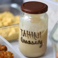 there is a jar that has tahiti dressing in it next to other food items