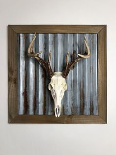 a deer's head mounted to the side of a wooden frame on a wall