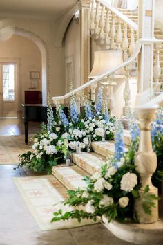 flowers and greenery are arranged on the stairs