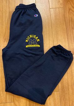 Champion Michigan Wolverines Mens Navy Blue Logo Sweatpants - 14751756 Blue Team Spirit Sports Bottoms, Blue Winter Activewear For Leisure, Casual Blue Winter Activewear, Blue Winter Leisure Activewear, Winter Blue Leisure Activewear, Collegiate Blue Sports Bottoms, Winter Sports Bottoms With Ribbed Cuffs, Navy Relaxed Fit Bottoms For Sports, Blue Bottoms With Elastic Waistband For Sports Events