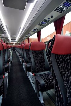 the interior of an airplane with red and black seats