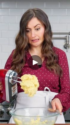 a woman is mixing some food in a bowl