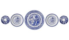 four blue and white plates sitting next to each other