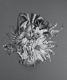 a black and white photo of flowers in the shape of a heart on a gray background