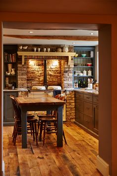 an open kitchen and dining room with wood flooring