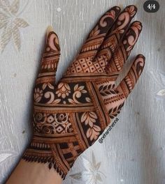 the hand is decorated with intricate designs on it