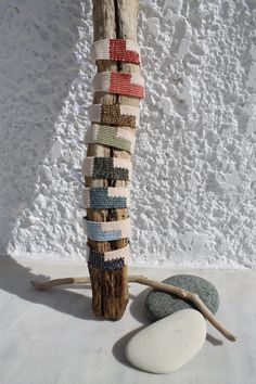 a wooden pole sitting next to two rocks on top of a white floor covered in snow