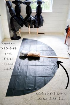 an upside down umbrella sitting on top of a floor next to two black chairs and a window