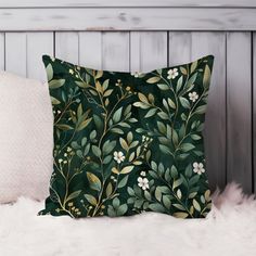 a green pillow sitting on top of a white furnishing next to a wooden wall