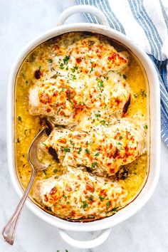 a casserole dish with chicken covered in cheese and parsley