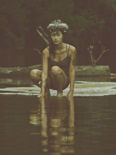 a woman kneeling down in the water with her hand on her hip and an inspirational quote