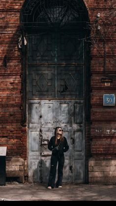 a woman standing in front of a door