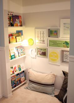 there is a small child's room with pictures on the wall and bookshelves