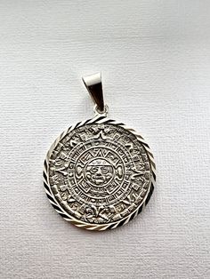 Sterling Silver Aztec Calendar Mayan Sun Charm Pendant Necklace Diamond-Cuts pre-Columbian-style medallion necklace pendant or bracelet charm depicting the Aztec/Mayan sun god exquisitely crafted in genuine 950 sterling silver with dazzling cut details Sterling Silver Medallion With Polished Finish, Sterling Silver Medallion Jewelry With Polished Finish, Polished Sterling Silver Medallion Jewelry, Silver Pendant With Diamond Cut, Silver Pendant Jewelry With Diamond Cut, Silver Diamond Cut Pendant Jewelry, Symbolic Engraved White Gold Jewelry, Sterling Silver Jewelry With Diamond Cut In Silver, Polished Sterling Silver Jewelry