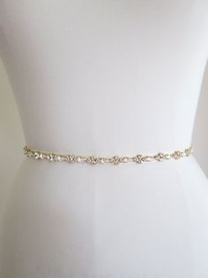 "This sparkly skinny bridal belt is made with Swarovski crystals beaded on 3/8\" wide grosgrain ribbon. The crystal part of the belt measures 24\" long and 3/8\" wide. The entire sash measures 150\" long. Available in gold, silver and rose gold finish. This belt can be made with organza, satin or grosgrain ribbon. * this belt can be made in any length, please inquire about a different length and pricing - For the photos of this belt in silver finish please take a look here: https://www.etsy.com/ Beaded Bridal Sash, Sparkly Belts, Gold Sash, Formal Belts, Bridal Sash Belt, Wedding Belt, Wedding Dress Belt, Crystal Belt, Wedding Sash Belt