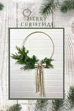 a christmas card with an image of a wreath and greenery hanging on a brick wall