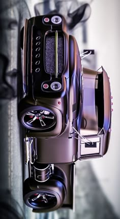 an overhead view of a black and silver toy car with wheels on it's tires