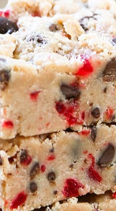 chocolate chip cookie bars stacked on top of each other with cranberry toppings