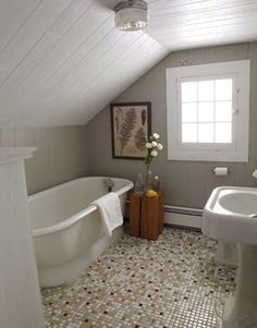 a bathroom with a sink, bathtub and window in the corner on the wall