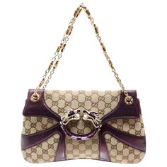 A GUCCI signature piece that will last you for many years From one of GUCCI's most stunning collections Very rare collectible item Made of the famous GG monogram canvas fabric with huge handcrafted jeweled dragon head enamel detail - a truly luxurious and elegant piece Purple leather trimming With gold-colored hardware Heavy golden chains in GUCCI's classic bamboo design Completely lined with brown fabric One side pocket inside Made in Italy Leather tag embossed with "GUCCI made in Italy" and se Vintage Gucci Bags, Mackenzie Hollister, 90210 Fashion, Gucci By Tom Ford, Vintage Designer Handbags, Tom Ford Bag, Vintage Evening Bags, Gucci Brand, Gg Monogram