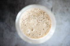 an overhead view of a drink in a blender with lots of frothy bubbles