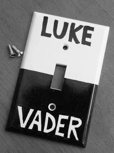 a white and black light switch cover with the words luke vader written on it