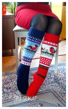 a woman is sitting on a chair with her legs crossed wearing christmas socks and stockings