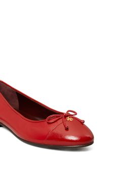 A gleaming logo accent and delicate bow enrich the cap toe of a timeless ballet flat rendered in rich leather. Leather upper, lining and sole Imported Red Ballet Flats, Flat Heels, Brick Lane, Womens Ballet Flats, Ballet Flat, Ballet Flats, Tory Burch, Leather Upper, Ballet