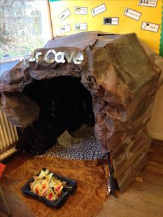 a room that has some kind of cave on the floor with food in front of it