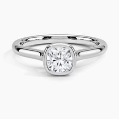 a white gold ring with a round diamond in the center