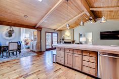 a kitchen with wood floors and wooden ceiling