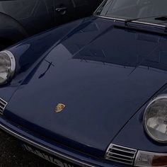 the front end of a blue porsche sports car