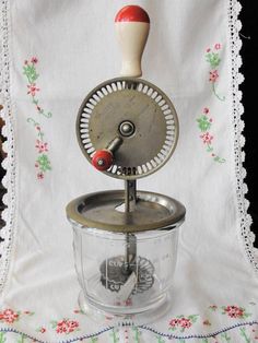 an old fashioned blender sitting on top of a table