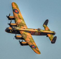 an old fashioned airplane flying in the sky