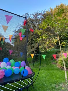 colorful balloons are placed on the back of a trampoline