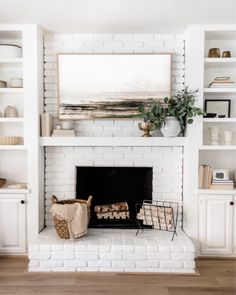 a white brick fireplace in a living room with bookshelves and baskets on the mantle