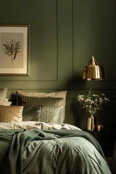 a bed with green walls and pillows in a bedroom next to a painting on the wall