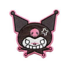 a pink and black patch with a cartoon character on it's face, in the shape