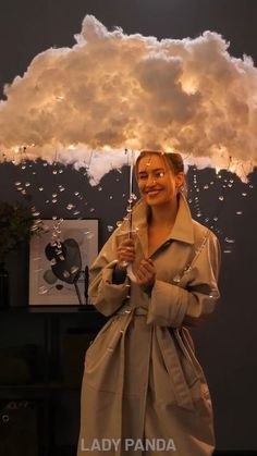 a woman is holding an umbrella in front of a cloud that looks like it has been raining