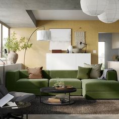 a living room filled with lots of green furniture