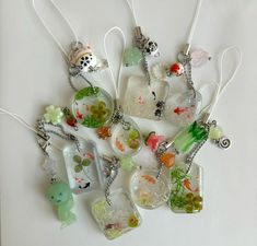 a collection of glass pendants with various designs on them, all in different shapes and sizes