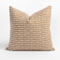 a brown and white striped pillow on a white background