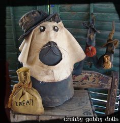 stuffed animals are sitting on a bench in front of a wooden wall with an old bag