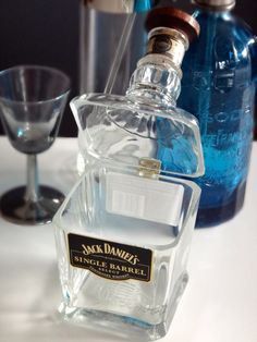 a bottle of jack daniels single barrel is sitting on a table next to two empty glasses